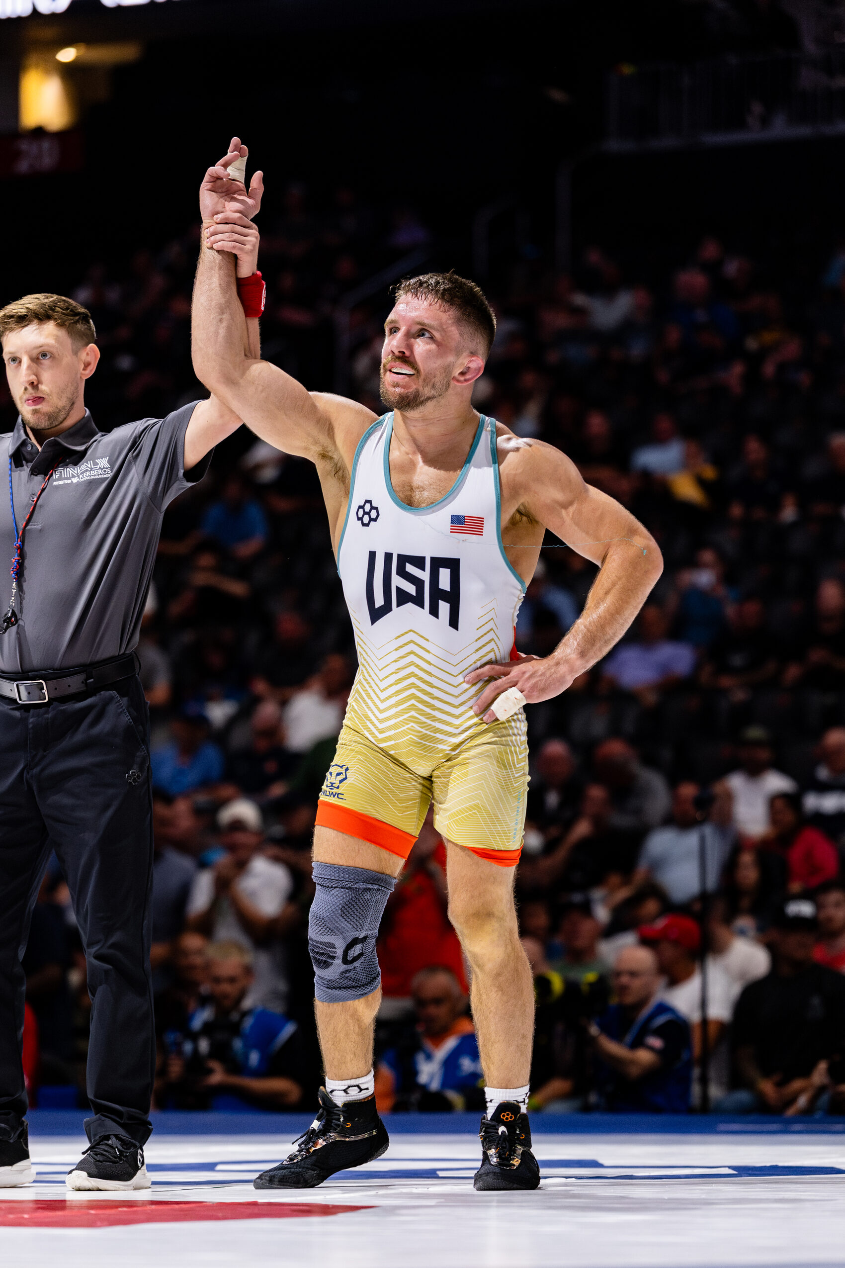 Zain Retherford has his hand raised in victory